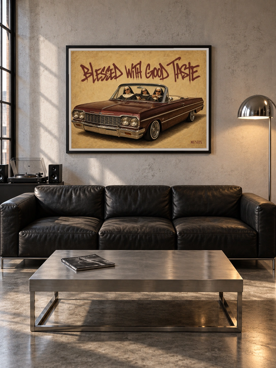 Blessed With Good Taste print, 48 × 36 inch, black frame above a leather sofa in a concrete-walled loft