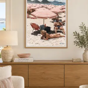 Copacabana Dreaming print, 30 × 40 inch, Natural Wood frame above a wood sideboard in a waterfront living room