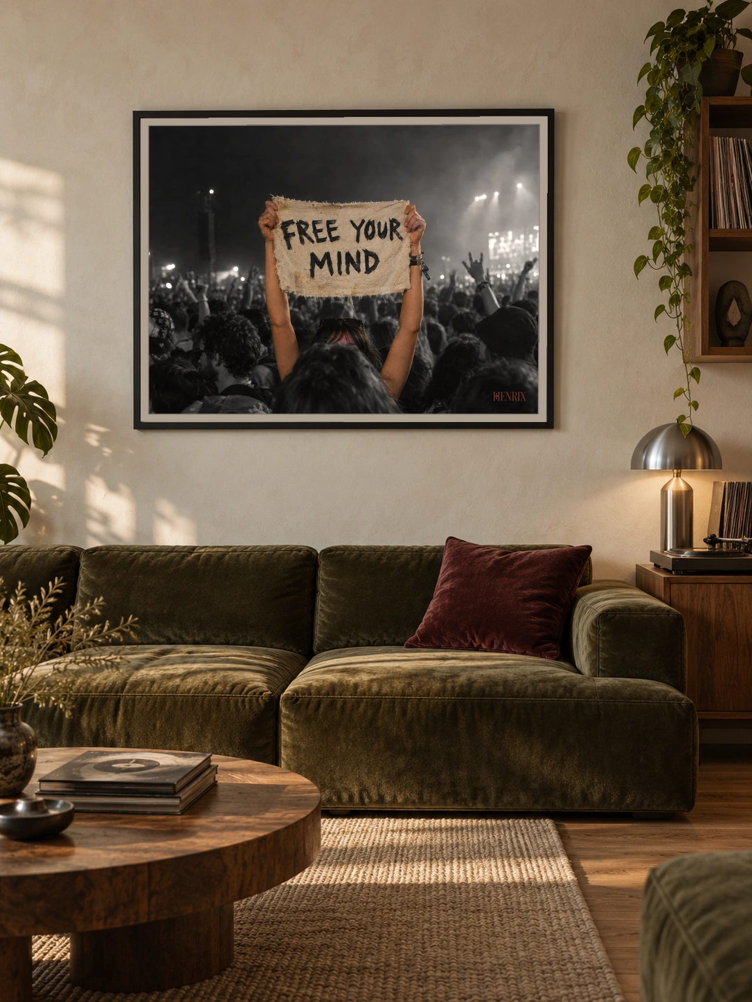Free Your Mind print, 40 × 30 inch, black frame above an olive-green living-room sofa