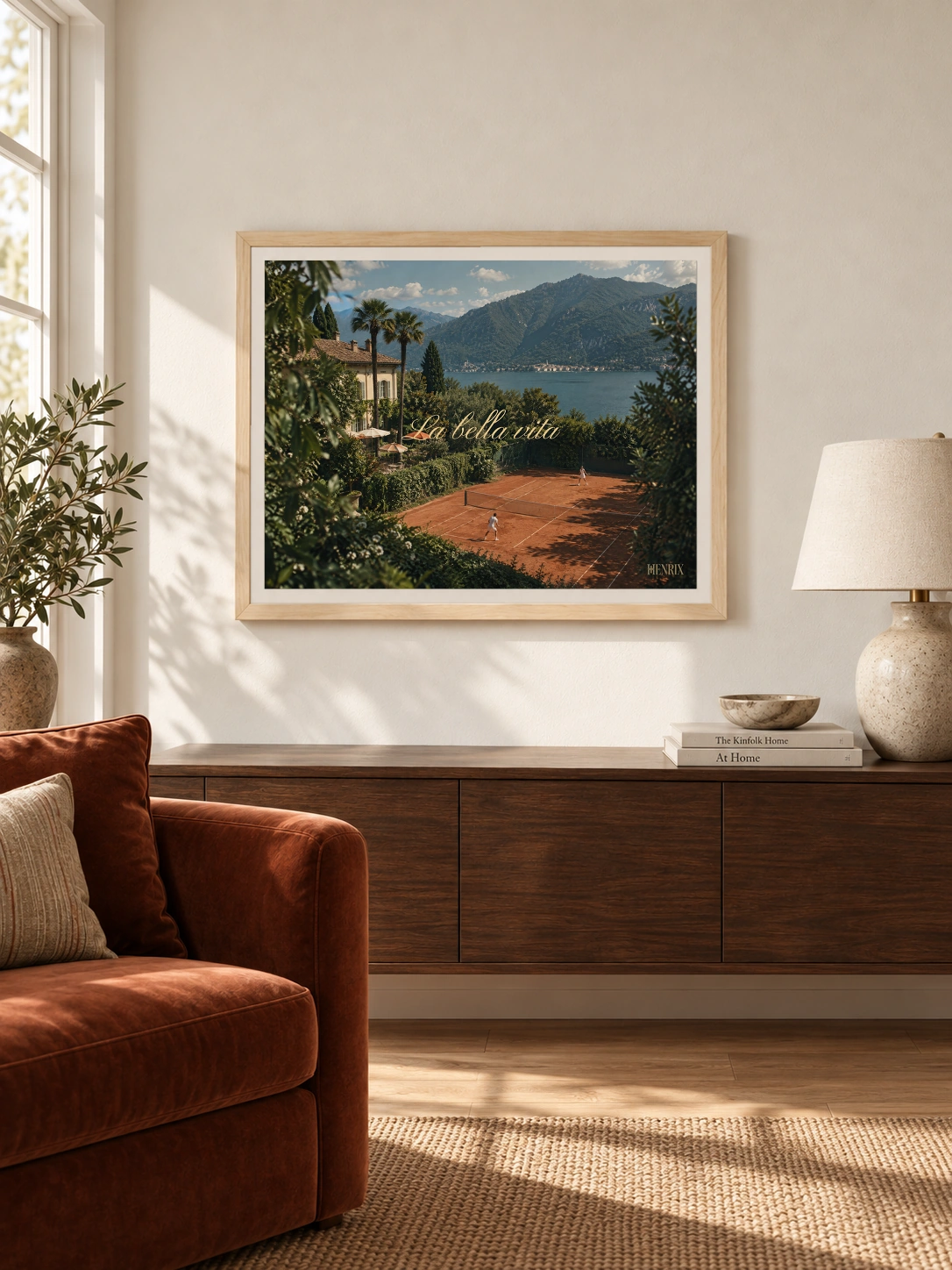 La Bella Vita print, 24 × 18 inch, Natural Wood frame above a long wood living-room sideboard