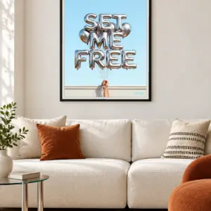 Set Me Free print, 30 × 40 inch, black frame above a cream living-room sofa