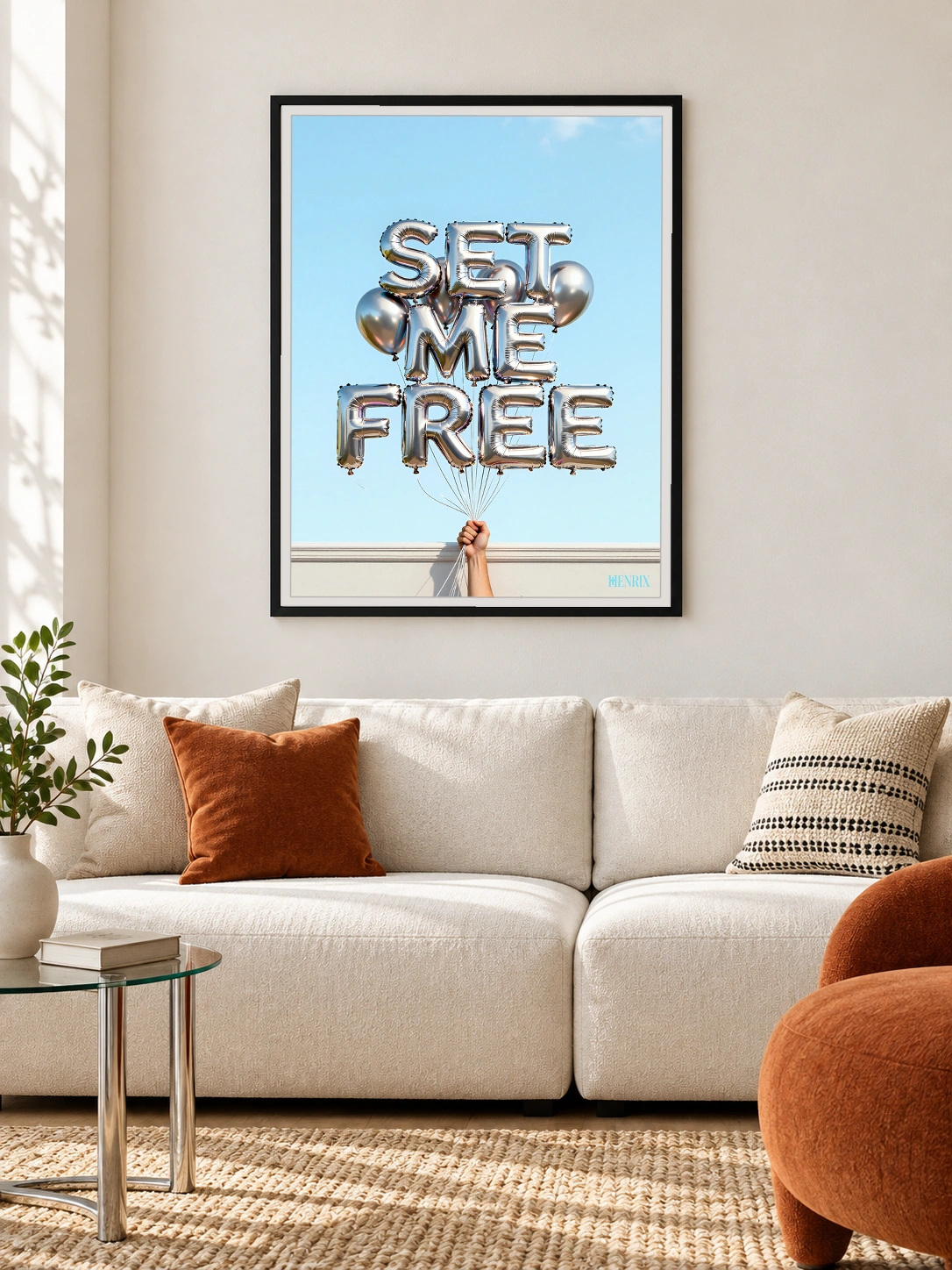 Set Me Free print, 30 × 40 inch, black frame above a cream living-room sofa