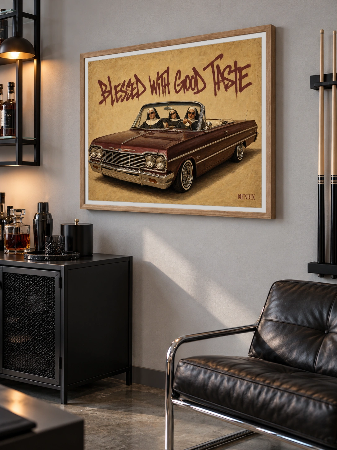 Blessed With Good Taste print, 40 × 30 inch, Natural Wood frame over a bar cabinet beside a leather chair, viewed at an angle