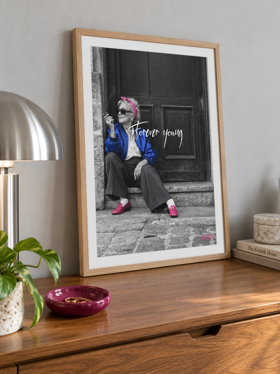 Forever Young print, 12 × 16 inch, Natural Wood frame leaning on a chest of drawers beside a pink bowl