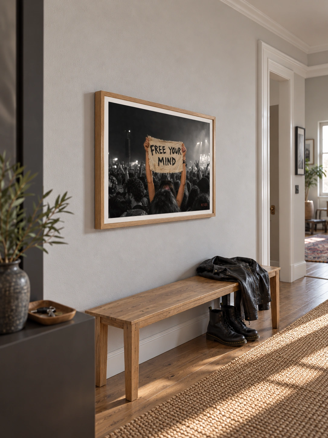 Free Your Mind print, 24 × 18 inch, Natural Wood frame above a hallway bench, viewed obliquely