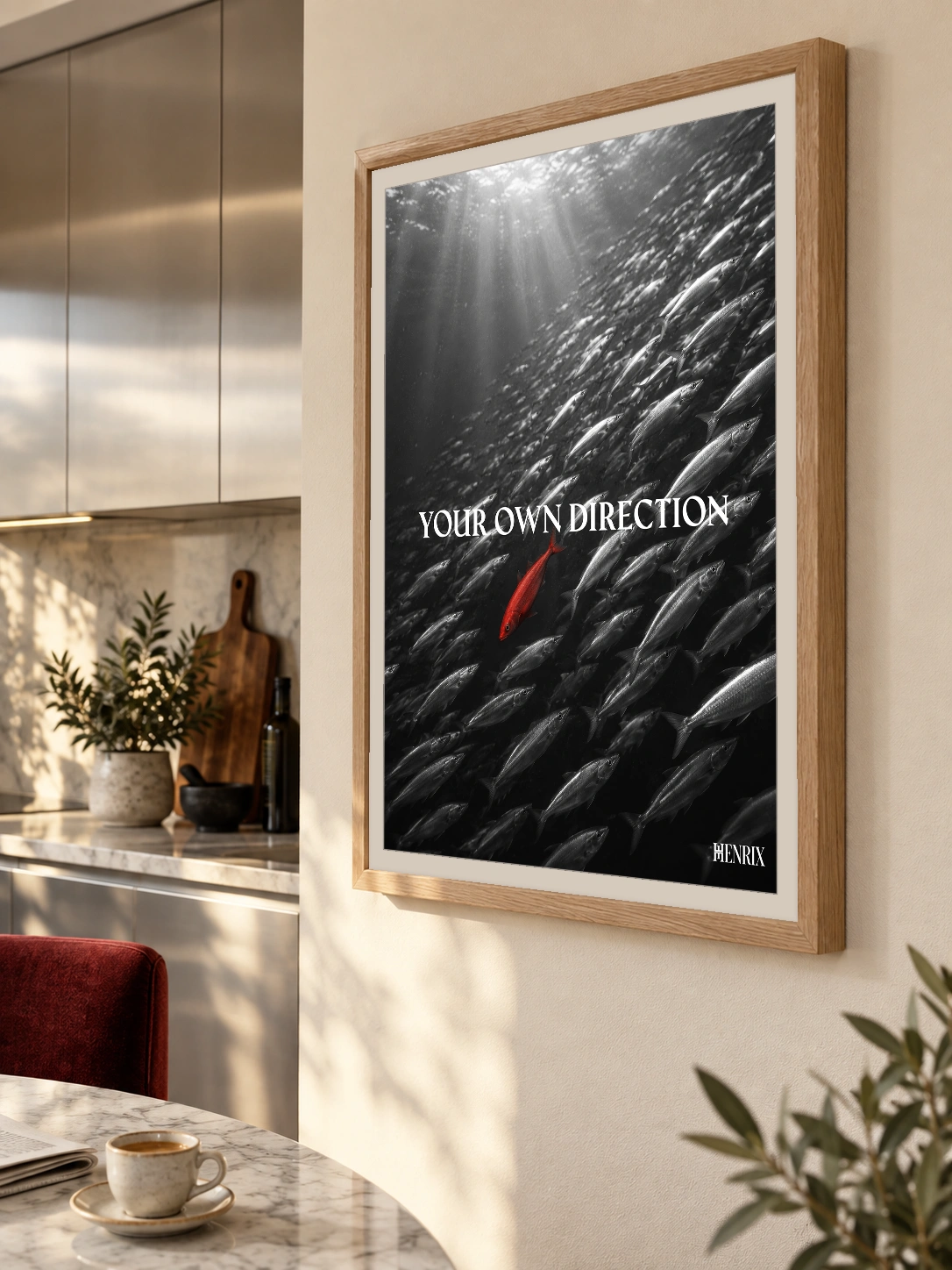 Your Own Direction print, 18 × 24 inch, Natural Wood frame beside a kitchen counter and dining table, viewed obliquely