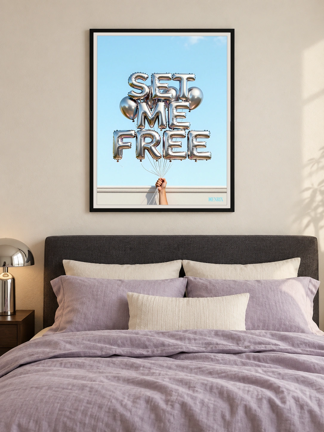 Set Me Free print, 30 × 40 inch, black frame above a bed with lilac bedding