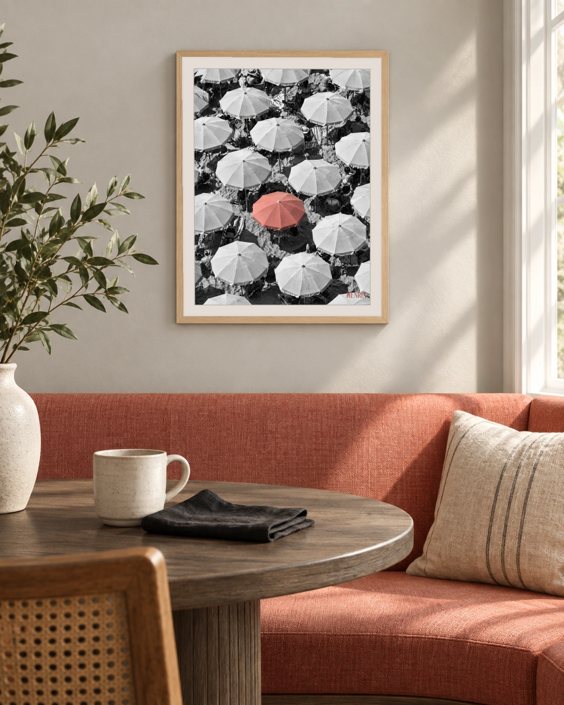 You Were Never Meant to Blend In print, 12 × 16 inch, Natural Wood frame above a coral dining banquette