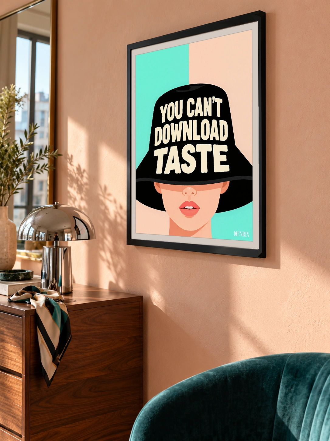 You Can't Download Taste print, 18 × 24 inch, black frame on a peach wall beside a wood desk, viewed obliquely