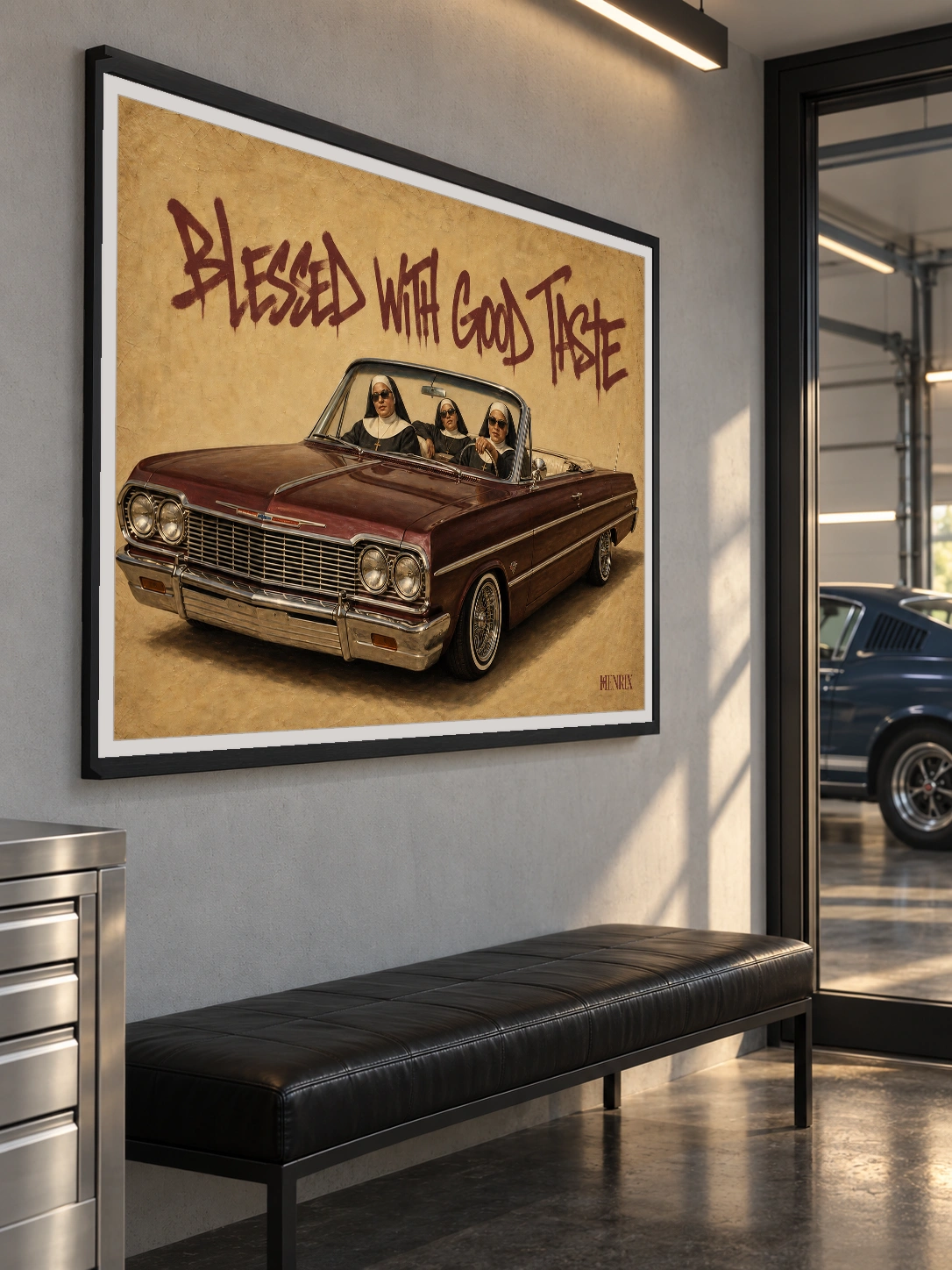 Blessed With Good Taste print, 40 × 30 inch, black frame above a leather bench near a garage window, viewed from the side