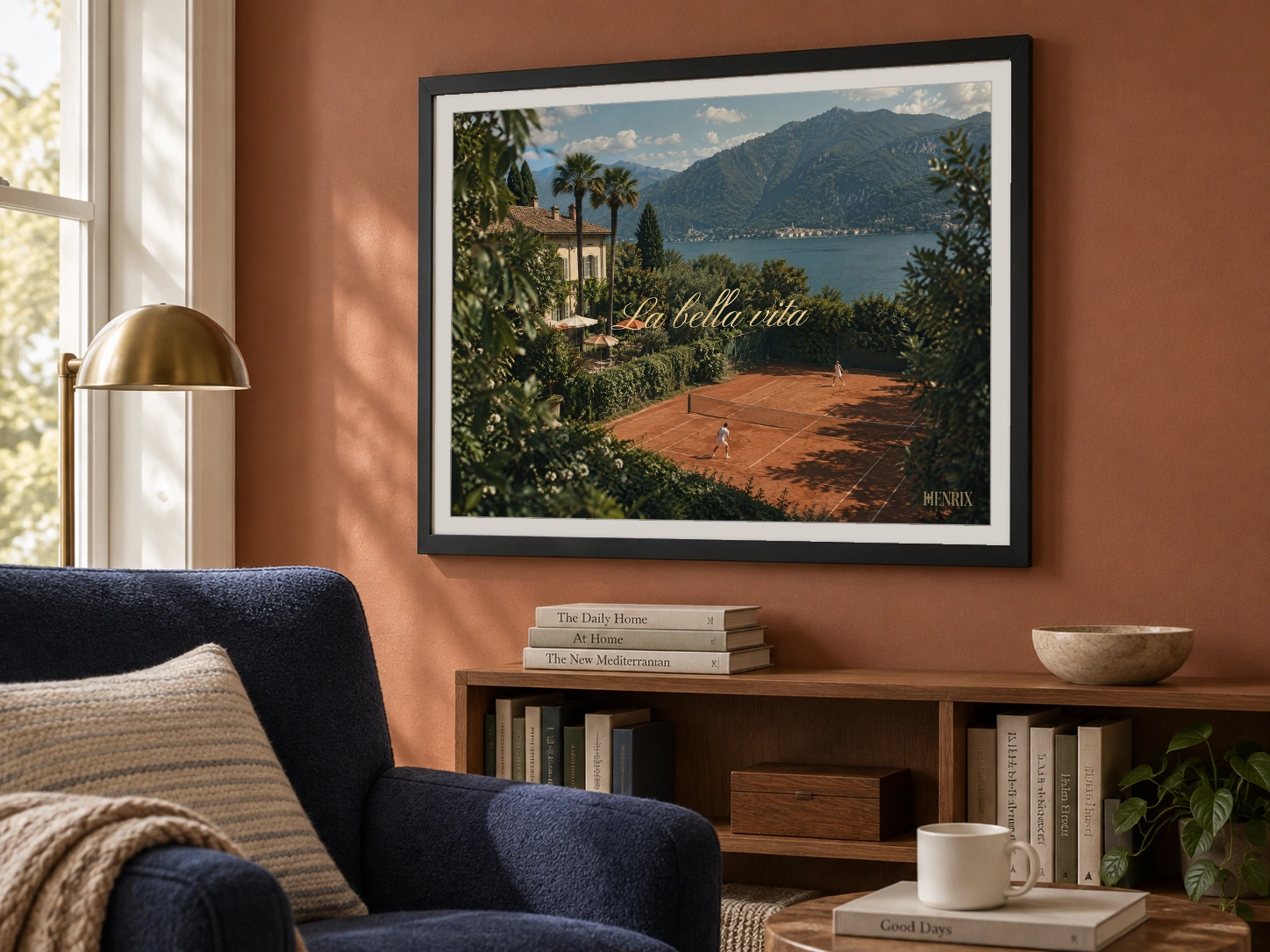 La Bella Vita print, 24 × 18 inch, black frame above a bookshelf on a terracotta sitting-room wall, viewed at an angle