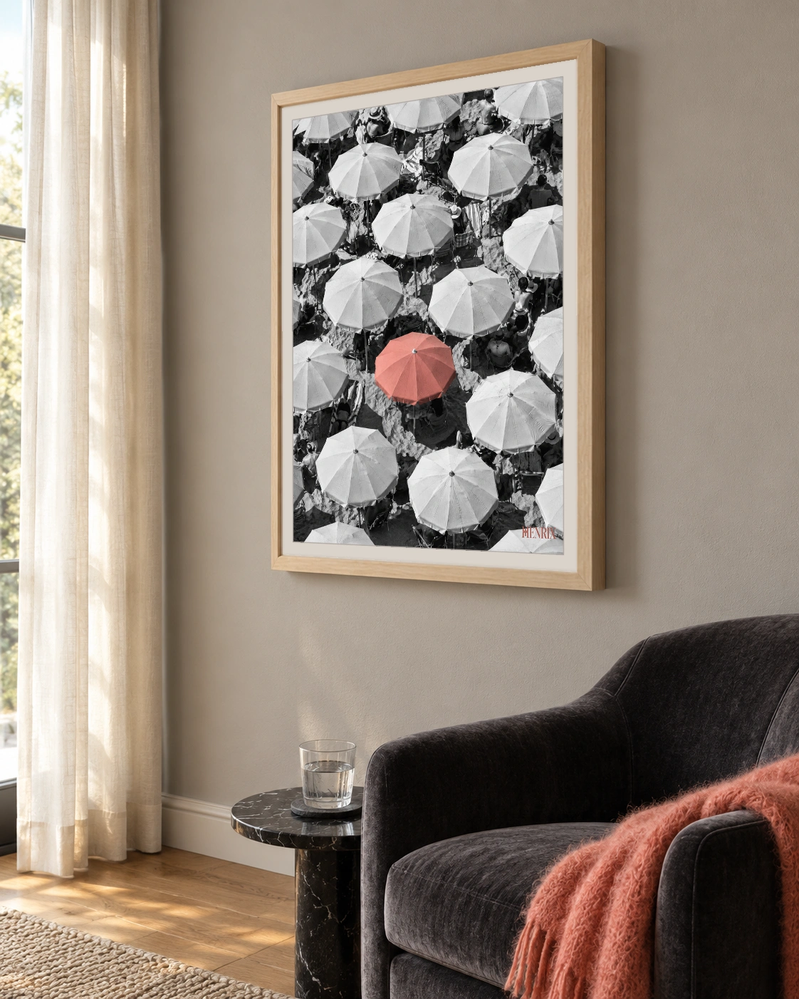You Were Never Meant to Blend In print, 18 × 24 inch, Natural Wood frame beside a dark armchair, viewed obliquely