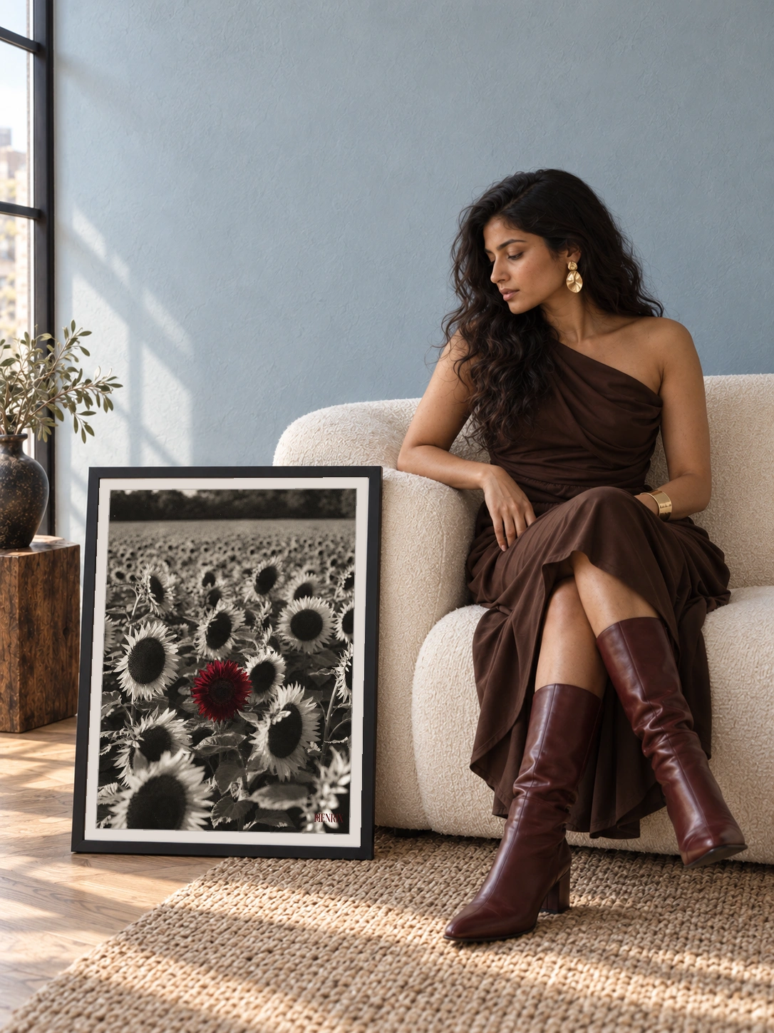 Grow Your Own Way print, 18 × 24 inch, black frame leaning on the floor beside a seated woman in a brown dress