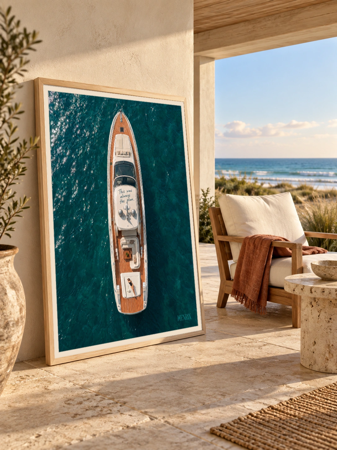 This Was Always the Plan print, 30 × 40 inch, Natural Wood frame on a covered beach-house terrace wall beside an ocean view